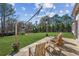 Inviting backyard patio with lounge chairs, string lights, and a lush green lawn at 5705 Windjammer Pt, Cumming, GA 30041