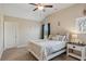 Cozy bedroom featuring a white bed, matching nightstand, and two windows for natural light at 5705 Windjammer Pt, Cumming, GA 30041