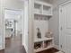 Inviting mudroom with built-in bench, storage cubbies, hooks, and access to the hallway and backyard at 5705 Windjammer Pt, Cumming, GA 30041