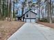 Two-story house with gray siding, two-car garage, and a long driveway at 3814 Whaley Ct, Snellville, GA 30039