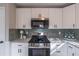 Modern kitchen with stainless steel appliances and granite countertops at 3814 Whaley Ct, Snellville, GA 30039