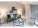 Living room with green sofa, fireplace and stairs to upper level at 3814 Whaley Ct, Snellville, GA 30039