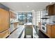 Modern kitchen with stainless steel appliances and light wood cabinets at 750 Park Ne Ave # 13W, Atlanta, GA 30326
