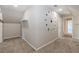 Finished attic featuring neutral walls, carpet, and decorative clock art at 1019 Walnut Creek Dr, Woodstock, GA 30188