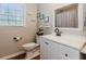 Bathroom with a white vanity, decorative mirror, and natural light at 1019 Walnut Creek Dr, Woodstock, GA 30188