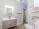 Bathroom with a modern vanity and light fixture, complemented by a toilet and subway tile backsplash at 1019 Walnut Creek Dr, Woodstock, GA 30188