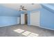 Large room painted blue featuring lots of space, a ceiling fan, and double door closet at 1019 Walnut Creek Dr, Woodstock, GA 30188