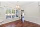 Inviting dining room with hardwood floors, windows, modern chandelier, and natural light at 1019 Walnut Creek Dr, Woodstock, GA 30188