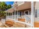 Charming covered front porch with stone steps, white railings, and space for seating at 1019 Walnut Creek Dr, Woodstock, GA 30188