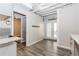 Basement kitchenette area featuring tiled backsplash, modern flooring, and access to the outdoors at 1019 Walnut Creek Dr, Woodstock, GA 30188