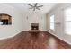 Open living room features hardwood floors, fireplace, ceiling fan, and natural light at 1019 Walnut Creek Dr, Woodstock, GA 30188