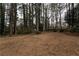 Open backyard space with a tree-filled backdrop at 1472 Silver Maple Sw Ct, Lilburn, GA 30047