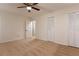 Bright bedroom with neutral carpeting, ceiling fan, and ample closet space at 1472 Silver Maple Sw Ct, Lilburn, GA 30047