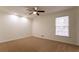 Bright bedroom with window and ceiling fan at 1472 Silver Maple Sw Ct, Lilburn, GA 30047