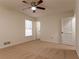 Well-lit bedroom featuring a ceiling fan and access to a bathroom at 1472 Silver Maple Sw Ct, Lilburn, GA 30047