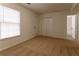 Well-lit bedroom with carpet and an attached bath at 1472 Silver Maple Sw Ct, Lilburn, GA 30047