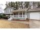 Gray house with white trim, front porch, and attached two-car garage at 1472 Silver Maple Sw Ct, Lilburn, GA 30047