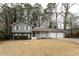 Two-story gray house with white trim, covered porch, and two-car garage at 1472 Silver Maple Sw Ct, Lilburn, GA 30047