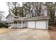 Gray two-story house with a two-car garage and front porch at 1472 Silver Maple Sw Ct, Lilburn, GA 30047