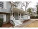 Welcoming front porch featuring white columns and bay window at 1472 Silver Maple Sw Ct, Lilburn, GA 30047