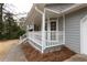 Inviting front porch with white railings and steps at 1472 Silver Maple Sw Ct, Lilburn, GA 30047