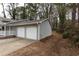 Two-car garage with white doors, located on the side of the house at 1472 Silver Maple Sw Ct, Lilburn, GA 30047