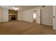 Gathering Room with stone fireplace and carpet flooring at 1472 Silver Maple Sw Ct, Lilburn, GA 30047