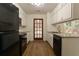 Galley kitchen with granite countertops and wood floors at 1472 Silver Maple Sw Ct, Lilburn, GA 30047