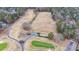 Aerial view of a golf course with trees and pathways at 2158 Belcourt Dr, Villa Rica, GA 30180