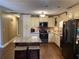 Spacious kitchen with granite island and hardwood floors at 2158 Belcourt Dr, Villa Rica, GA 30180