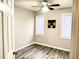 Bright bedroom with two windows, ceiling fan, and wood-look flooring at 1040 Hillsborough Chase Nw, Kennesaw, GA 30144