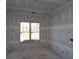 Bright bedroom with window, drywall installation in progress at 1975 Sage Lake Bend Sw, Marietta, GA 30064