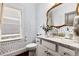 Stylish powder room with patterned wallpaper and granite countertop at 370 Park Ne Pl, Atlanta, GA 30317