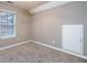 Bright bedroom featuring a window with blinds and carpeting at 4948 Emmett Still Rd, Loganville, GA 30052