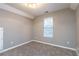 Well-lit bedroom with carpeted floor and window at 4948 Emmett Still Rd, Loganville, GA 30052