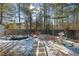 Landscaped backyard with pond, stone pathway, and wooden fence at 1112 Autumn Glen Way, Dacula, GA 30019