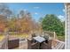 Deck overlooking backyard with wooded area and patio furniture at 3525 W River Commons, Douglasville, GA 30135