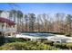 Community pool with a winter cover and surrounding fence at 705 Woodshire Sw Trl, Atlanta, GA 30331