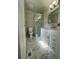 Renovated bathroom featuring new shower, vanity, and updated marble-look floors at 3967 Evelyn Dr, Powder Springs, GA 30127