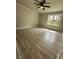 A bright bedroom features wood-look floors and a large window to let in natural light at 3967 Evelyn Dr, Powder Springs, GA 30127