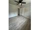 A bedroom with wood-look floors is equipped with a closet and a ceiling fan at 3967 Evelyn Dr, Powder Springs, GA 30127