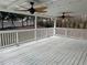 Spacious covered deck featuring two ceiling fans and white railing, perfect for outdoor relaxation at 3967 Evelyn Dr, Powder Springs, GA 30127