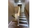 Well-lit staircase with hardwood steps and white risers, complemented by a wooden handrail at 3967 Evelyn Dr, Powder Springs, GA 30127