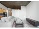 Living room and kitchen with city views, light wood floors, modern cabinets and gray sectional couch at 3324 Peachtree Ne Rd # 1503, Atlanta, GA 30326