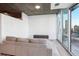 Living room showing large windows with city views, hardwood floors, and a couch at 3324 Peachtree Ne Rd # 1503, Atlanta, GA 30326