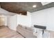Living room and kitchen with hardwood floors, gray sectional couch, and modern cabinets at 3324 Peachtree Ne Rd # 1503, Atlanta, GA 30326