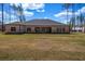 Expansive backyard view showcasing the home's brick exterior and covered patio at 125 Drummond Pl, Covington, GA 30014