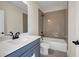 Well-lit bathroom featuring a tub, shower and vanity with a sink and black hardware at 125 Drummond Pl, Covington, GA 30014