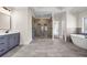 Spacious bathroom with a soaking tub, walk-in shower, double vanity, and marble tile floor at 125 Drummond Pl, Covington, GA 30014