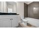 Modern bathroom featuring a white vanity with a black countertop and a shower-tub combo at 125 Drummond Pl, Covington, GA 30014